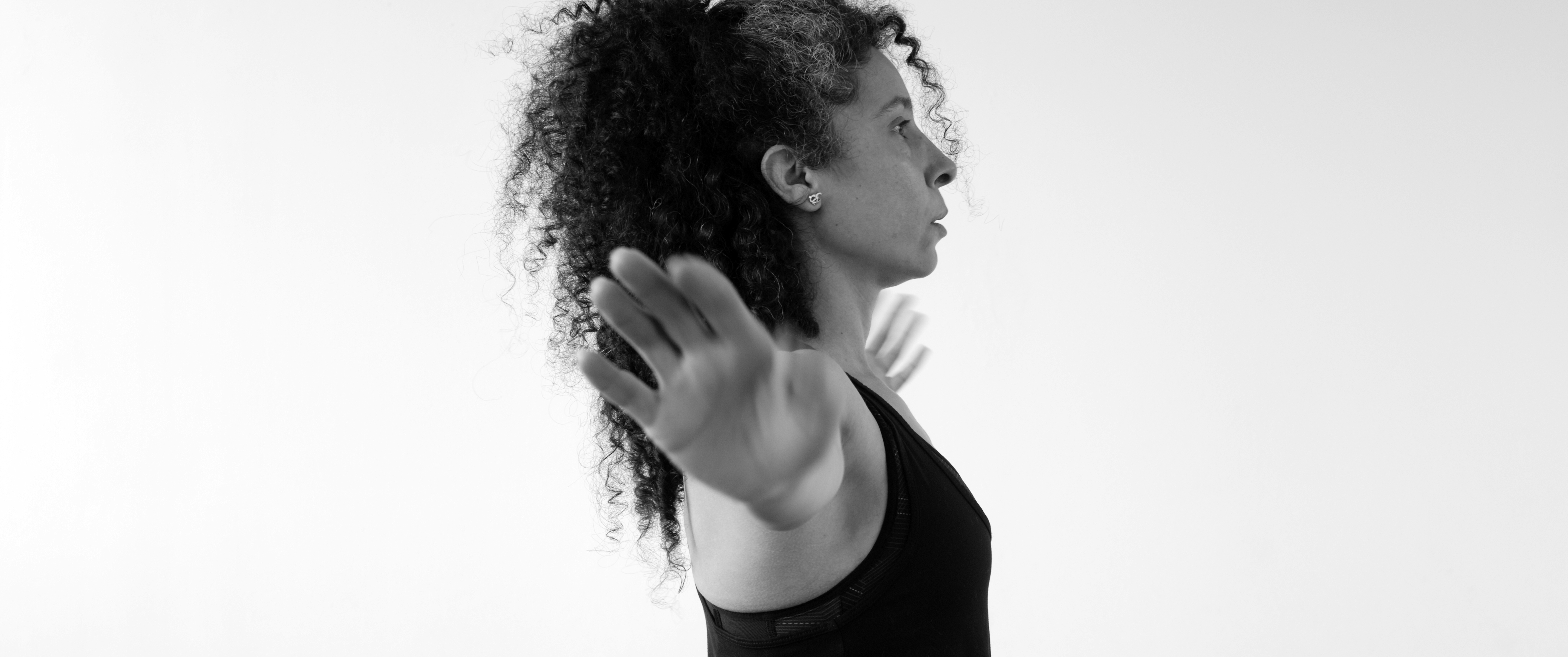 Wide shot, black and white. Gheorghe is alone in the middle of a field, playing his violin.